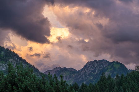 Stormy and dramatic clouds over the mountains near Oberstdorf, Allgau, Germanyの写真素材