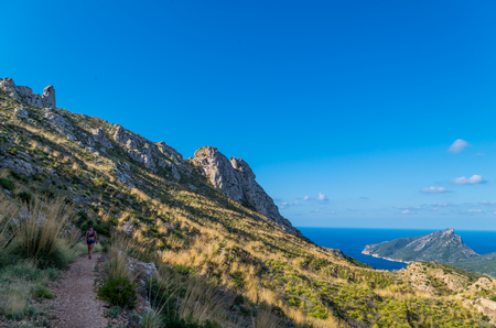 Female hiking in the mountains at the coast of Tramuntana, Mallorca, Baleares, Spainの写真素材