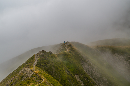 Female trailrunning in the foggy mountains of Lechtal Alps, North Tyrol, Austriaの写真素材