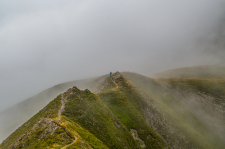 Female trailrunning in the foggy mountains of Lechtal Alps, North Tyrol, Austriaの写真素材