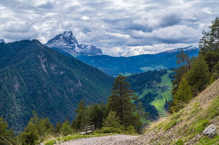 Dramatic clouds over mountain Peitlerkofel in south tyrol, near San Vigilio, Italyの写真素材