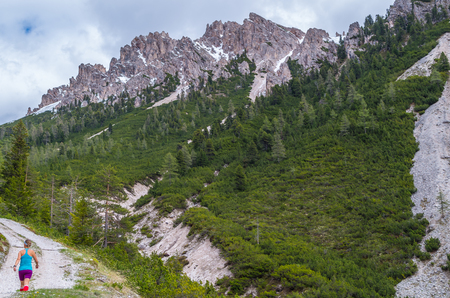 Female trailrunning in the mountains of dolomites in Val Gardena, South Tyrol, Italyの写真素材