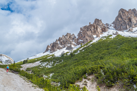 Female trailrunning in the mountains of dolomites in Val Gardena, South Tyrol, Italyの写真素材