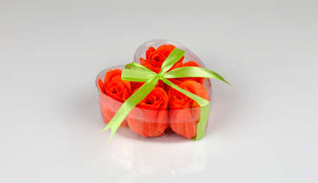 Gift heart with red roses inside with a ribbonの写真素材