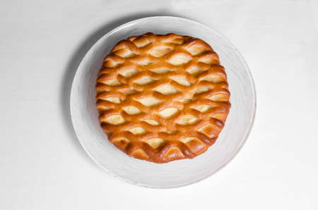 Loaf and a plate on a white tablecloth