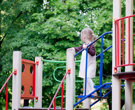 Little girl standing on a lplaygroundの写真素材
