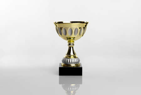 gold trophy cup on white acrylic backgroundの写真素材