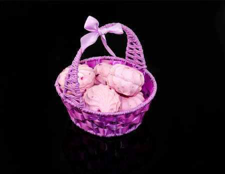Berry purple zephyr in the basket on a black mirrored backgroundの写真素材