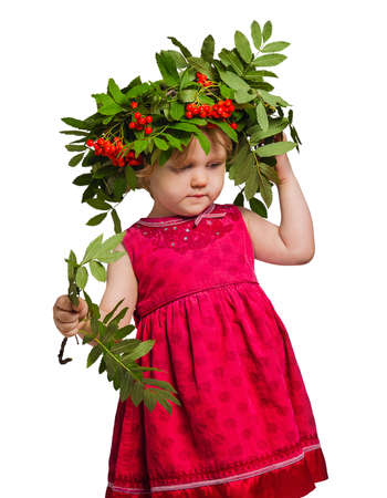 Little girl with a wreath of twigs and fruits of mountain ash on his head and Rowan branches in their hands isolated on whiteの写真素材