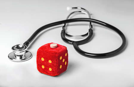 Stethoscope and toy dice photo white backgroundの写真素材