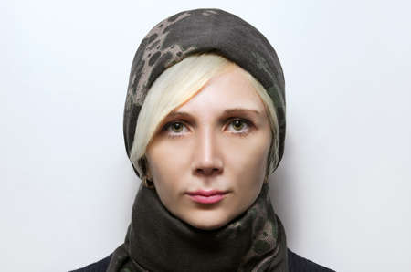 White beautiful blond Caucasian woman with a scarf wrapped on his head portrait photo studioの写真素材