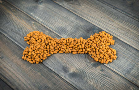 animal bones laid out on wooden background of dry food for dogs and cats photo imageの写真素材