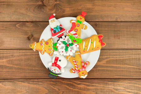wood on a white plate background Christmas tree cookies, santa, middle-aged man, snowman, snowflake, candy. New year foodの写真素材