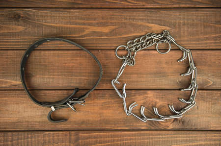 Collar leather and strict on the wooden background in comparisonの写真素材