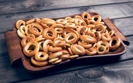 On gray wooden background bagels drying of different sizesの写真素材