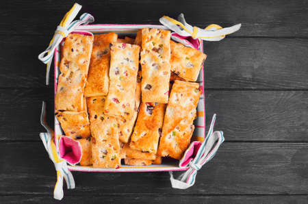 Breakfast tissue basket box with freshly baked cookies on a dark black wooden background, top viewの写真素材