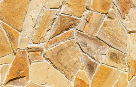 The stone brick wall yellow brown, texture backgroundの写真素材