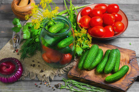 Preserving pickled cucumbers and tomatoes, herbs for canning preserving rosemary, dill, parsley,...
