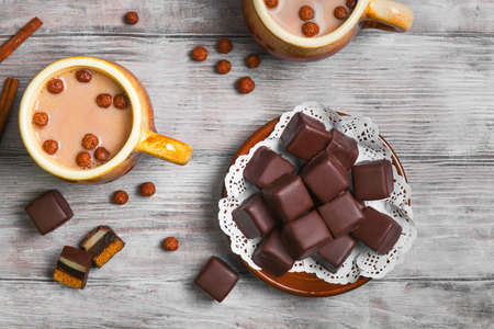 Traditional German domino stein chocolate gingerbread cakes with marzipan and jelly filling. Hot chocolate cocoa two cups. Chocolate balls for domino stein gingerbread and hot chocolate. Top viewの写真素材