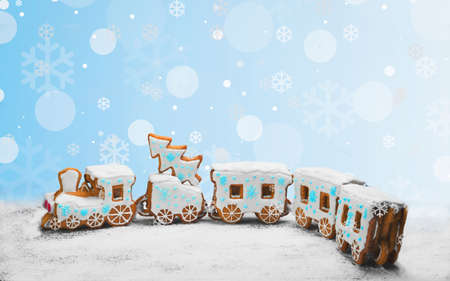 Gingerbread Cookies in the form of train. Christmas cookies train covered with icing. Christmas Holidays sweets Gingerbread Cookies train.  New Year card with snow, Christmas gingerbread cookies trainの写真素材