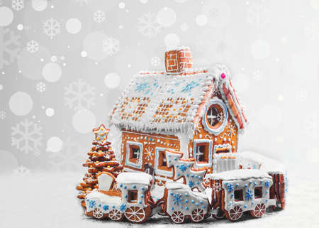 Assorted Christmas gingerbread cookies. Christmas gingerbread village, house, train, tree. Christmas New Year's background with snowflakes. Christmas card with gingerbread village.の写真素材