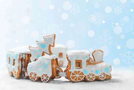 ngerbread Cookies in the form of train. Christmas cookies train covered with icing. Christmas Holidays sweets Gingerbread Cookies train.  New Year card with snow, Christmas gingerbread cookies trainの写真素材