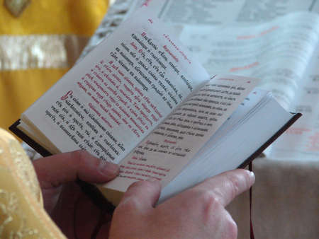 Slavic Gospel in hands of russian orthodox priest