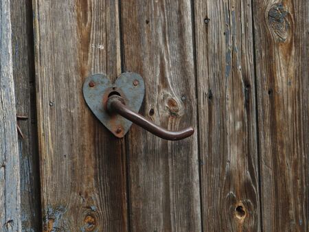 Aged door handle on wooden doorの写真素材