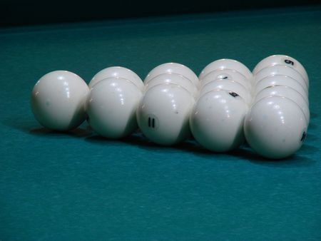 White balls on green textile pool table