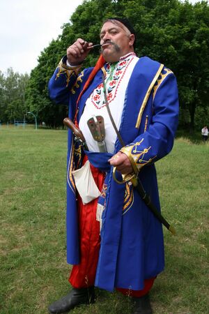 Old ukrainian Cossack with long whiskers smoking pipeの写真素材
