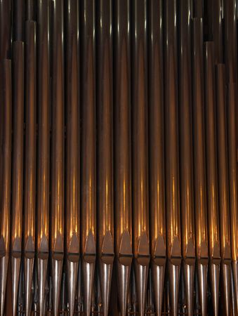 Vertical row of old shiny organ metal pipesの写真素材