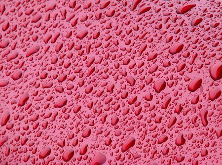 water drops texture on red backgroundの写真素材
