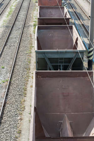 The old dirty cargo train with empty cars.