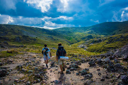 People hiking on the hills with cloudsのeditorial素材