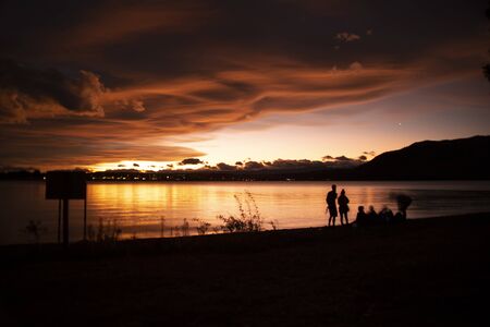 summer colorful Sunset at lake tekapo shoreの写真素材