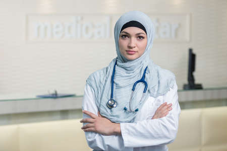 Closeup portrait of friendly, smiling confident muslim female doctor.の写真素材