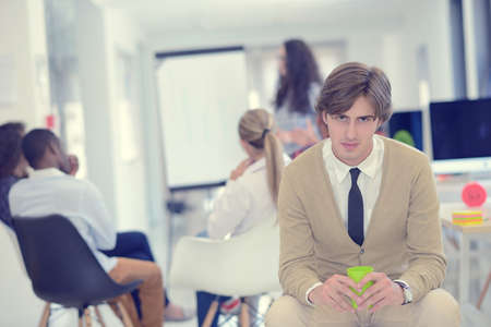 business, startup and people concept - happy creative team talking in officeの写真素材