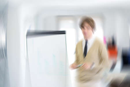 Freelancer looking at his ideas written on paper at modern startup officeの写真素材