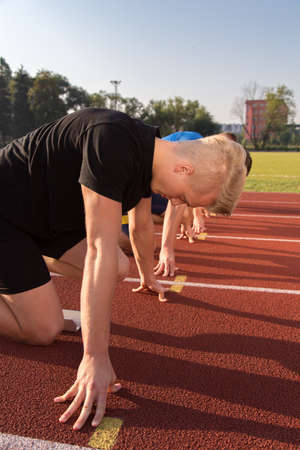Athletic man starting evening jogging in sun rays