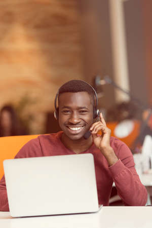 Customer Service agent in an startup office with laptop