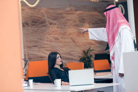 Woman office worker gets fired by arab businessmanの写真素材