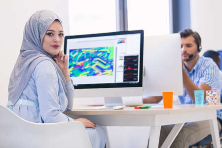 Young Arabic business woman wearing hijab,working in her startup office.の写真素材