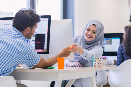 Multiracial contemporary business people working on computersの写真素材