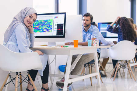 Young Arabic business woman wearing hijab,working in her startup office.の写真素材