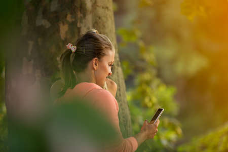 Beautiful girls taking a selfie with a smart phone before going for a run outdoors.の写真素材