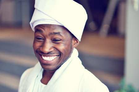 Sudanese business man in traditional outfit using mobile phone in office.の写真素材