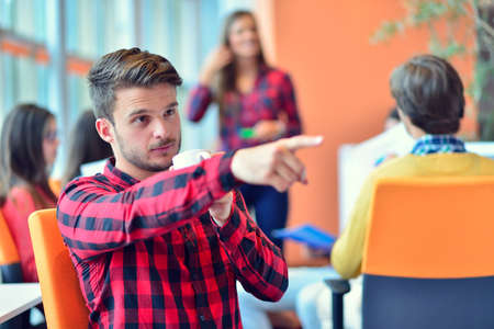 Portrait of an handsome businessman in front of his working team.の写真素材