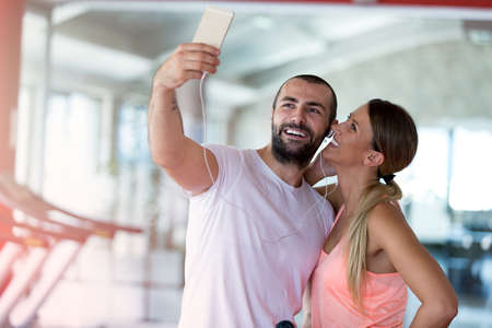 Young couple taking a sefie in a gym.の写真素材