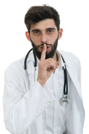 Serious male doctor instruct to keep silence.の写真素材