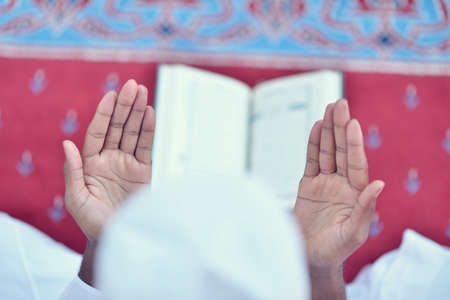 African Muslim Man Making Traditional Praying To God While Wearing A Traditional Cap Dishdashaの写真素材